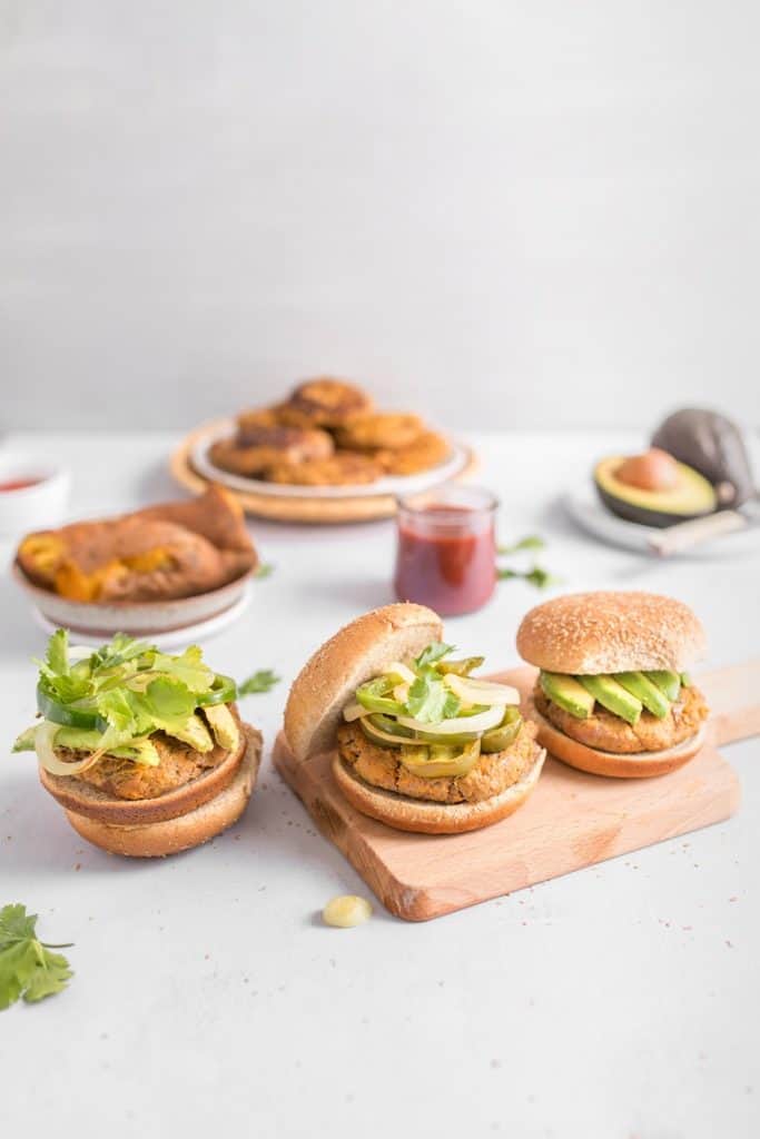Turkey and sweet potato burgers topped with avocado and on a bun 