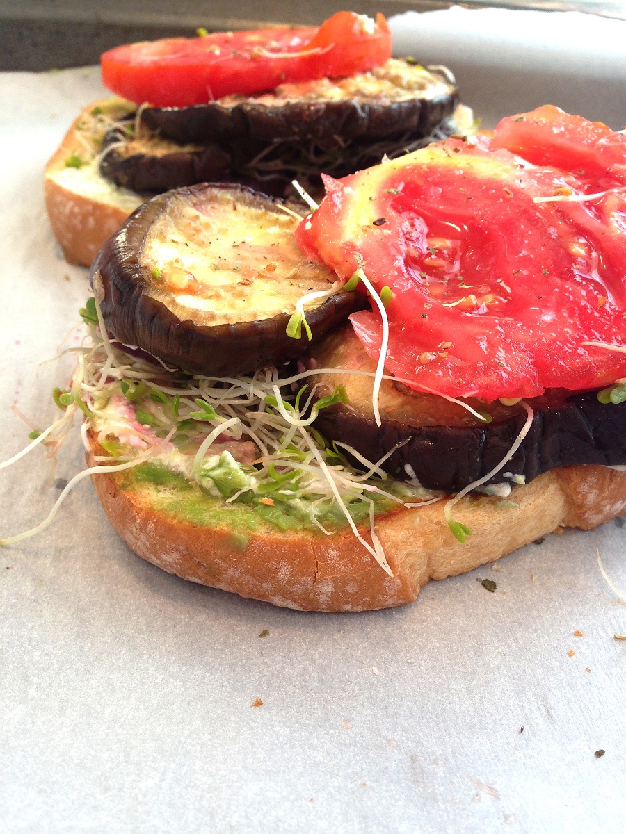 Open faced sandwich with eggplant, tomatoes and sprouts