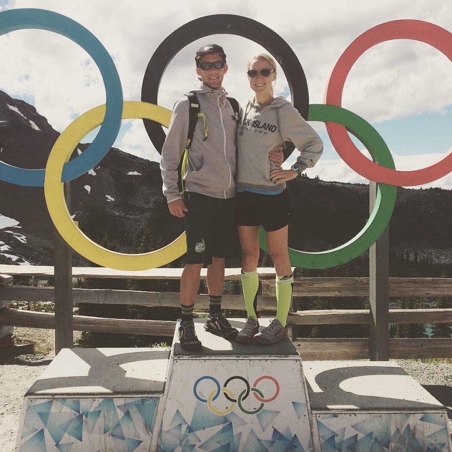 man and woman in front of olympic rings in Whistler, BC