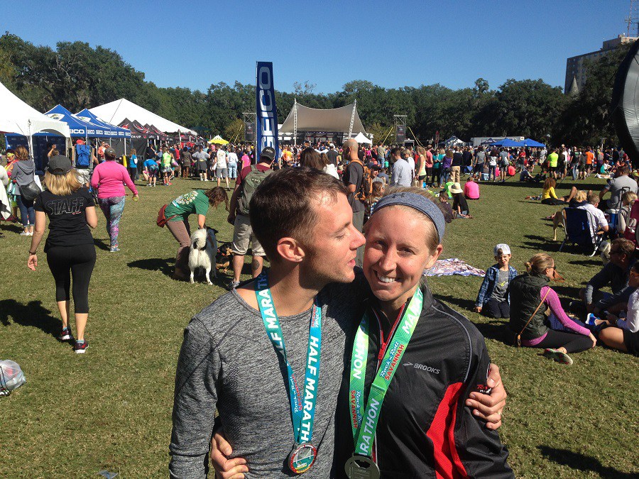 Husband Kissing Wife after finishing marathon in green park area