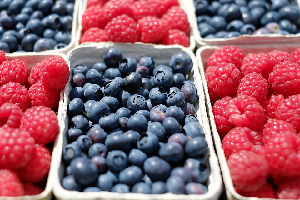 strawberries and blueberries at grocery store