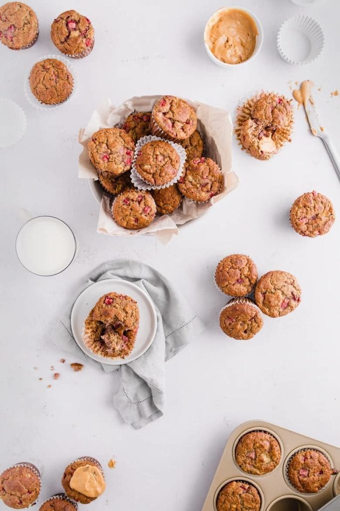 Basket of gluten free strawberry muffins with peanut butter next to them 