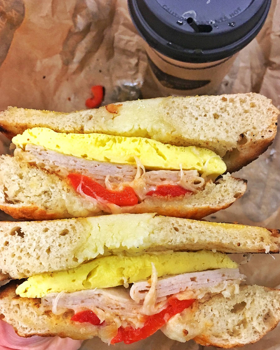 breakfast sandwich with eggs, turkey, cheese and tomato
