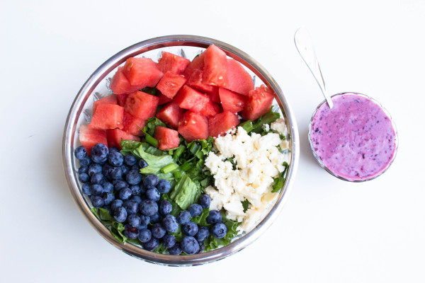 watermelon, blueberries, cheese on salad in clear serving bowl
