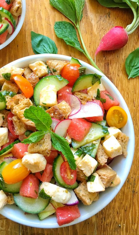 watermelon panzanella salad with croutons and tomatoes in white serving bowl