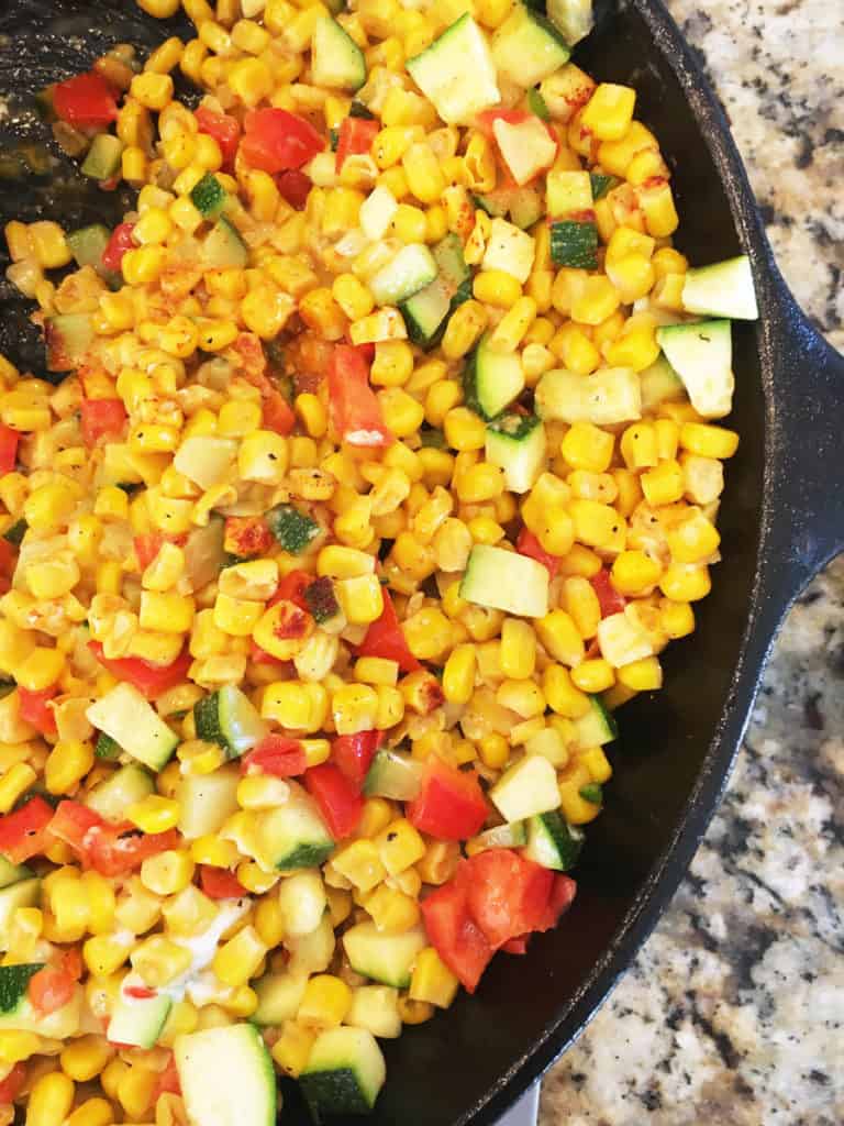 Zucchini dip with Mexican street corn in cooking skillet | Bucket List Tummy