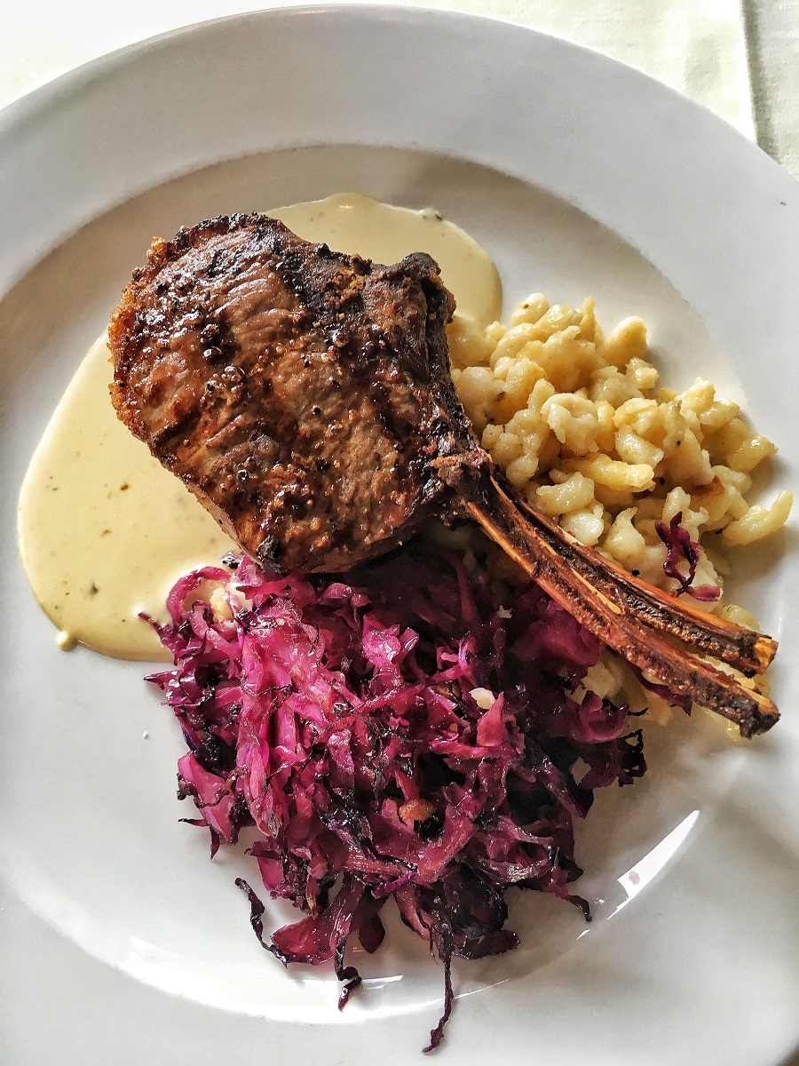 elk chop with cabbage and rice on white plate