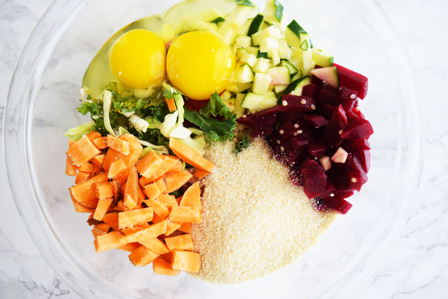 clear bowl with breadcrumbs, sweet potatoes, eggs and beets