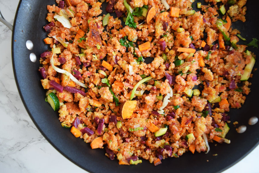 cooking skillet with beet and sweet potato scramble with quinoa