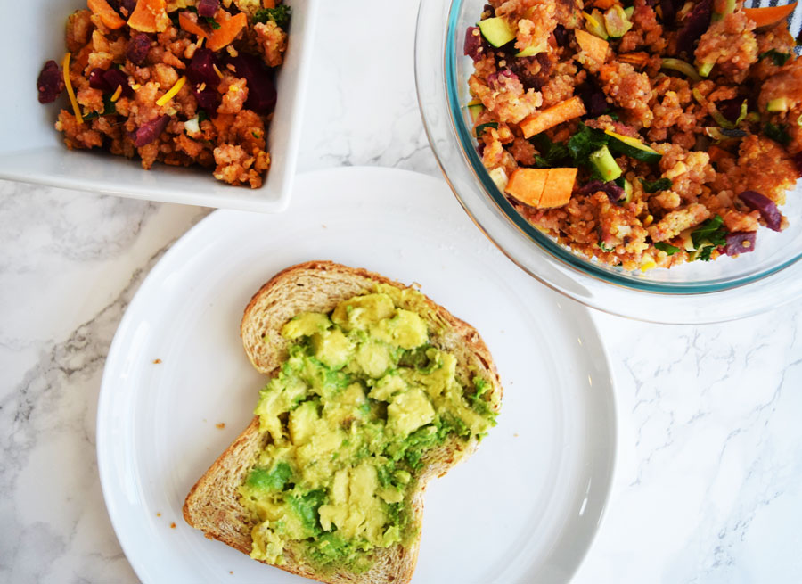 avocado toast on white plate and quinoa beet scramble in clear bowl