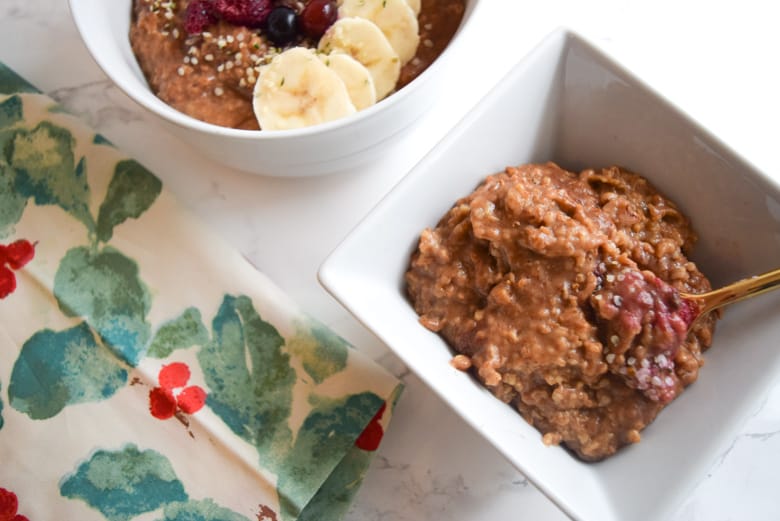 Gingerbread oatmeal in white bowl with holiday napkin next to it, a great holiday breakfast recipe