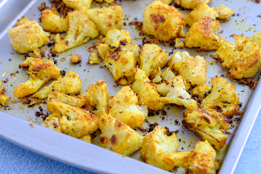 Crispy Turmeric Baked Cauliflower is the perfect appetizer, or fun veggie side dish. With flavors of garlic ad cheese, finished with a soft crunch, you'll never want to prepare cauliflower any other way!  