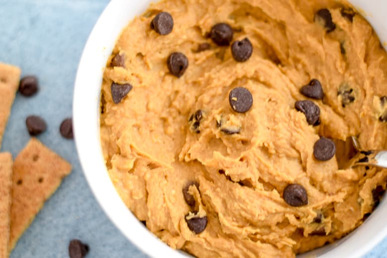 Closeup of Sweet Potato Edible Vegan Cookie Dough Dip with chocolate chips on blue background