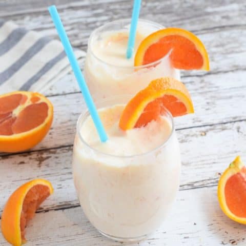 orange mango smoothie with cara cara oranges in wine glasses | Bucket List Tummy