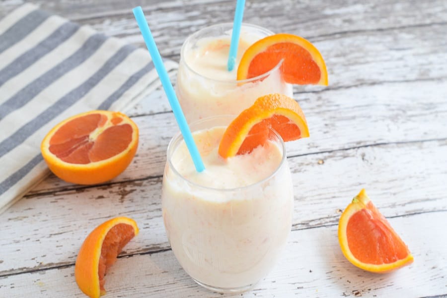 orange mango smoothie with cara cara oranges in wine glasses | Bucket List Tummy