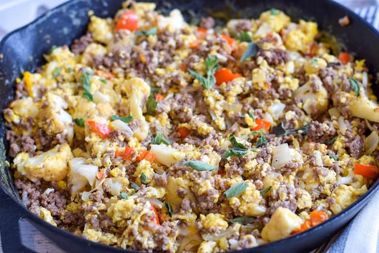 cast iron skillet with breakfast scramble made with ground beef, eggs and veggies