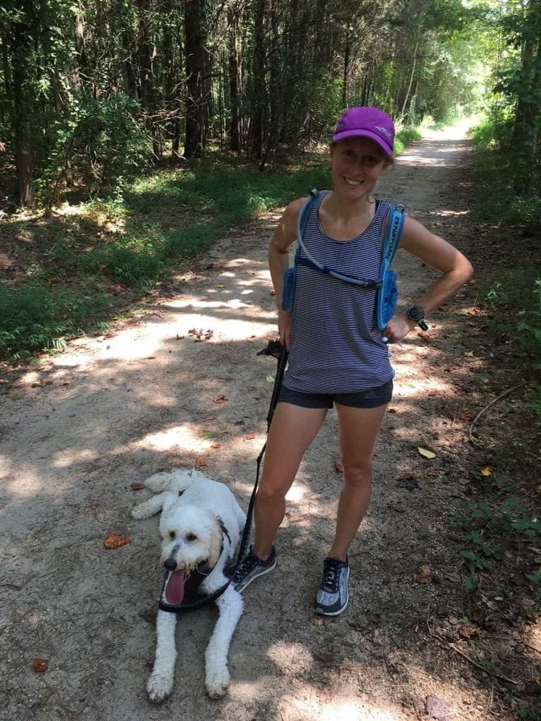 Girl on running trail with dog