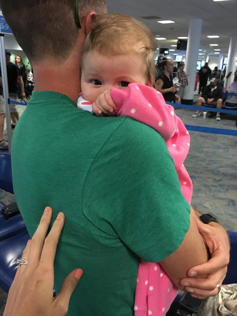 Picture of dad holding infant in airport