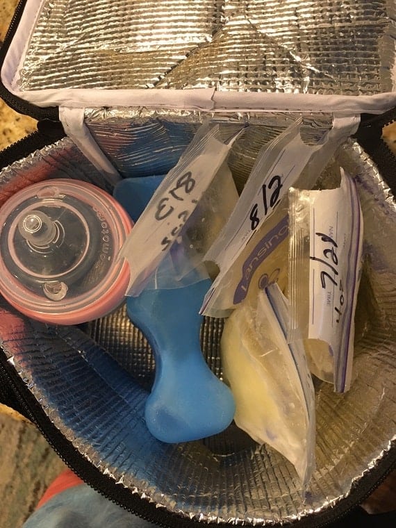 Small black breastmilk cooler with ice and bags of breastmilk 