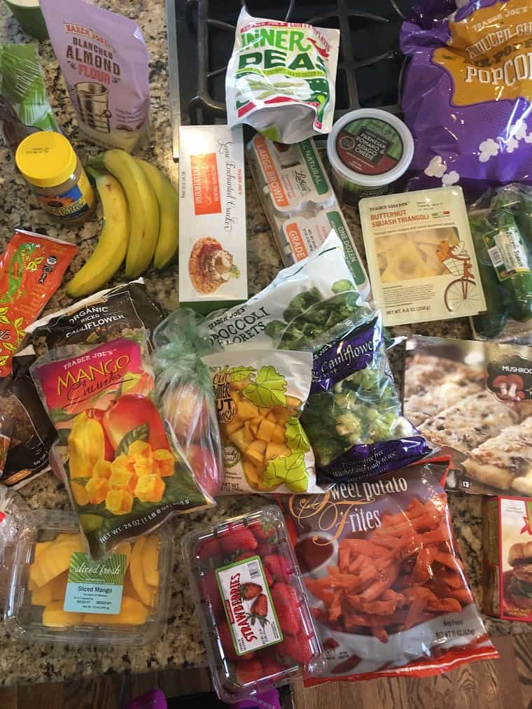 Frozen produce and examples of groceries on a kitchen countertop from recent grocery shopping at Trader Joe's