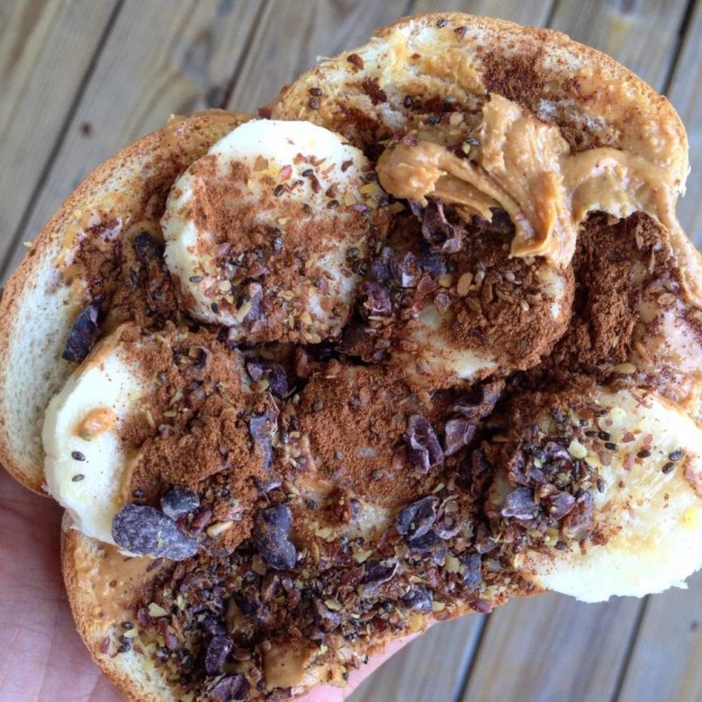 Toast with peanut butter, flax seeds, banana and cocoa nibs