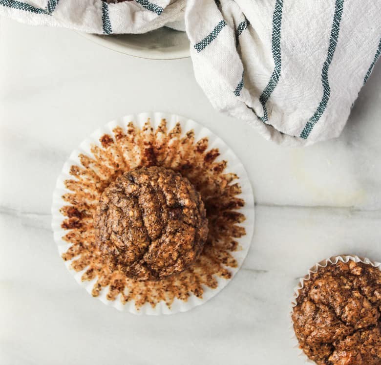 Banana almond muffins close up in muffin wrapper | Bucket List Tummy