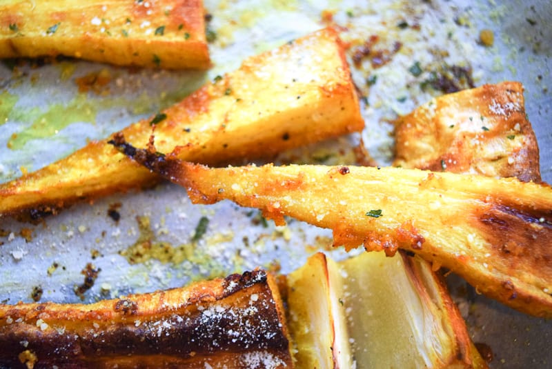 Close up of crispy roast parsnip fries on baking dish | Bucket List Tummy