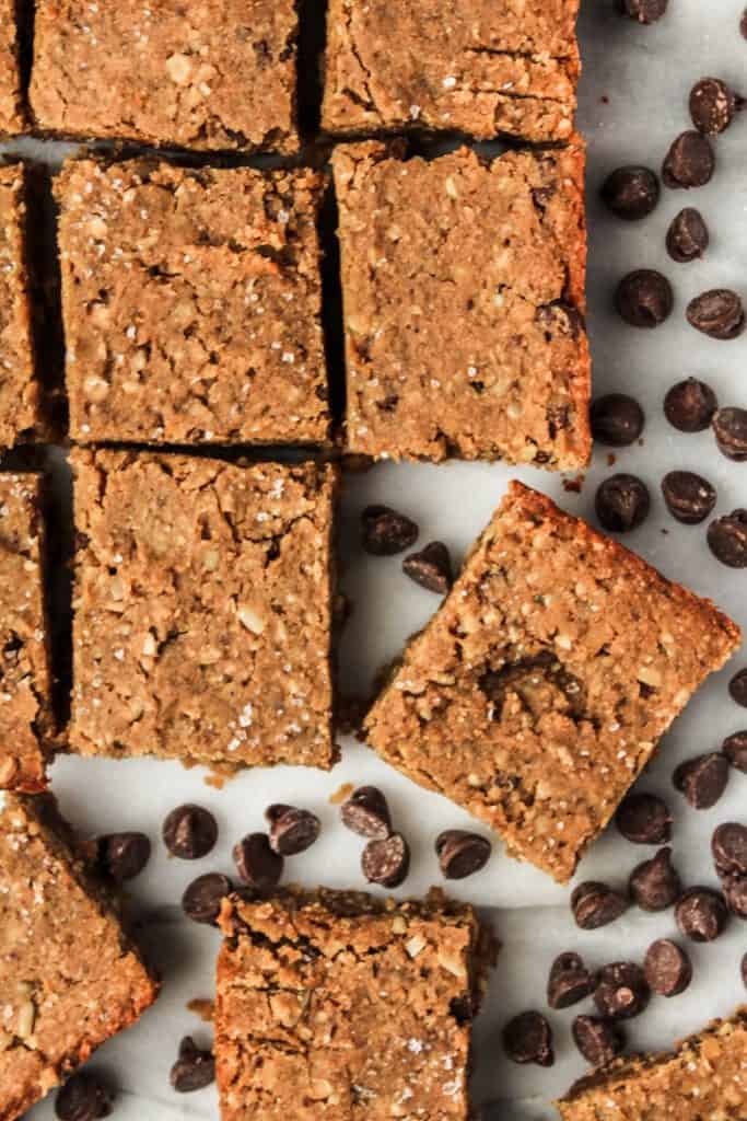 Overhead view of vegan protein bars with chocolate chips on gray countertop