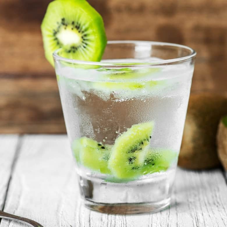 glass of water with kiwi for hydration before exercise