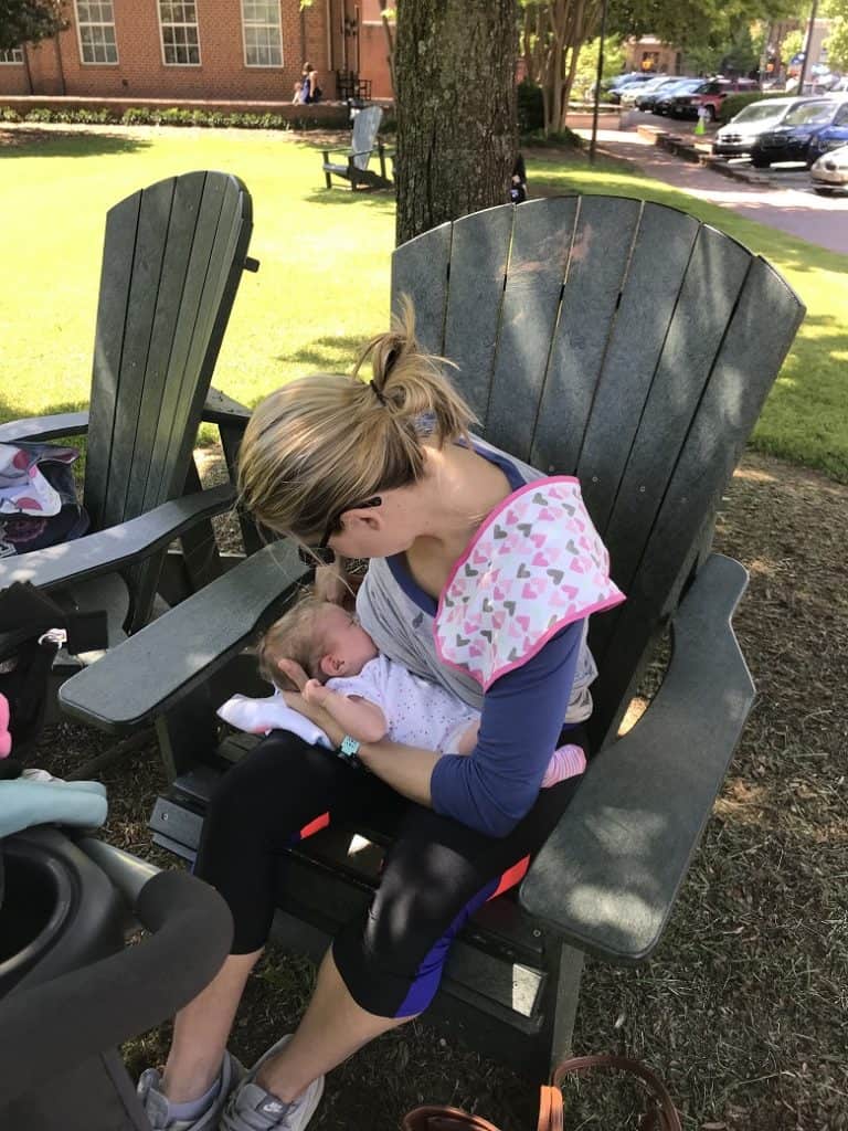 Mom nursing baby on chair outside