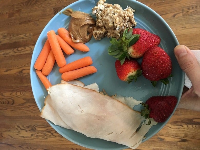 Snack plate with carrots, turkey, strawberries and peanut butter