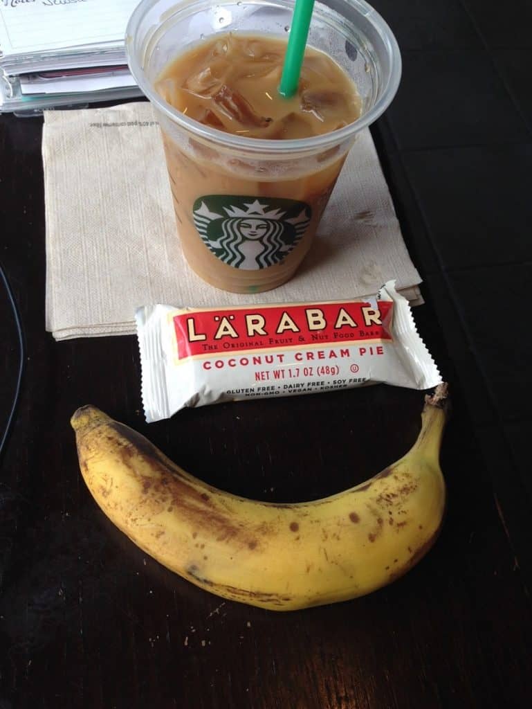 banana, coconut cream pie larabar and iced coffee on a napkin 