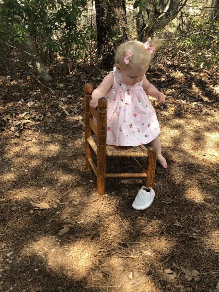 one year old sitting on wooden chair