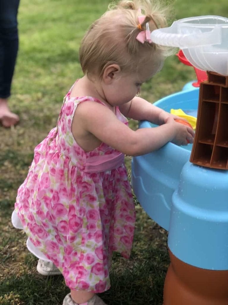 Baby playing at water table