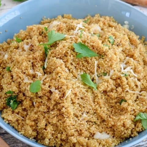 lemon herb cheesy quinoa in blue bowl close up | Bucket List Tummy