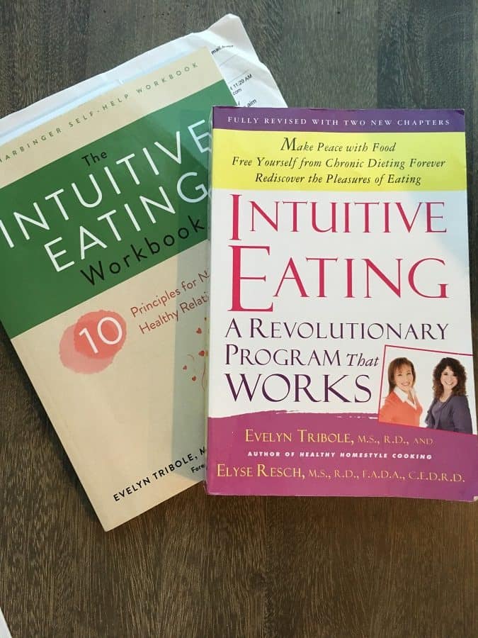 intuitive eating book and workbook on wooden table