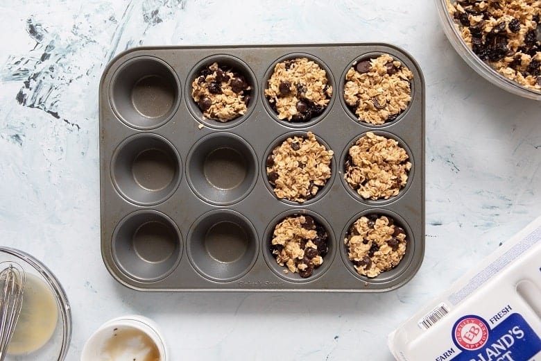 Muffin pan with batter for Cherry Chocolate Baked Oatmeal Cups 