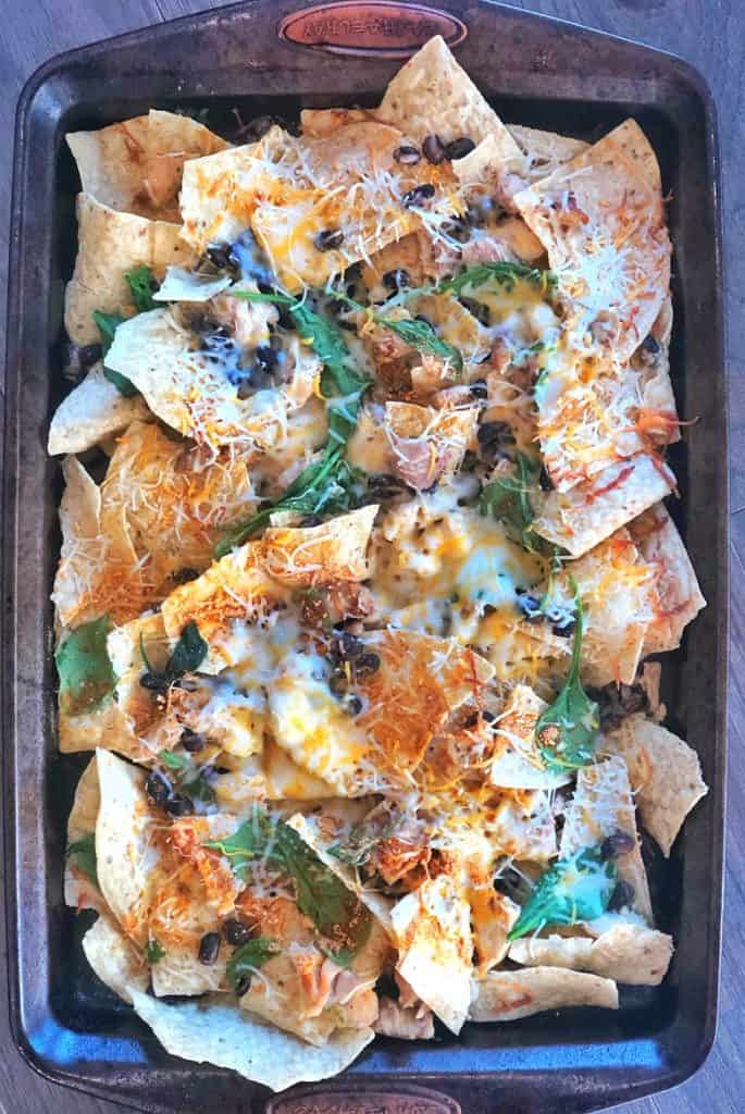 homemade nachos with cheese on sheetpan