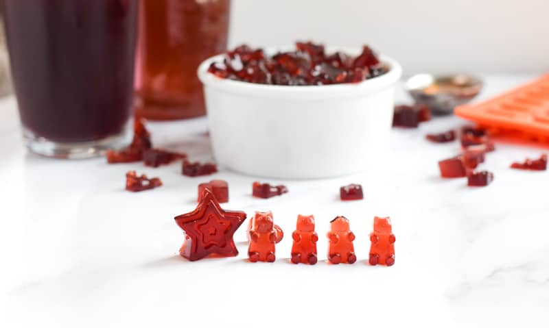 Tart Cherry Gummies on white countertop with more gummies in the background