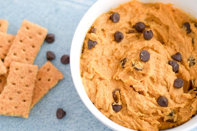 Sweet potato vegan edible cookie dough dip in bowl with chocolate chips on graham crackers on side for dipping | Bucket List Tummy