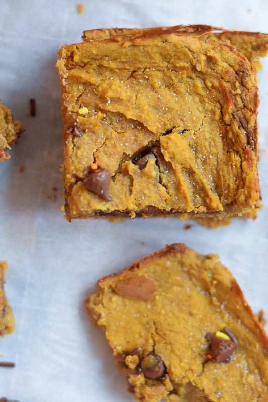 Overhead view of pumpkin chickpea bars with sea salt on parchment paper
