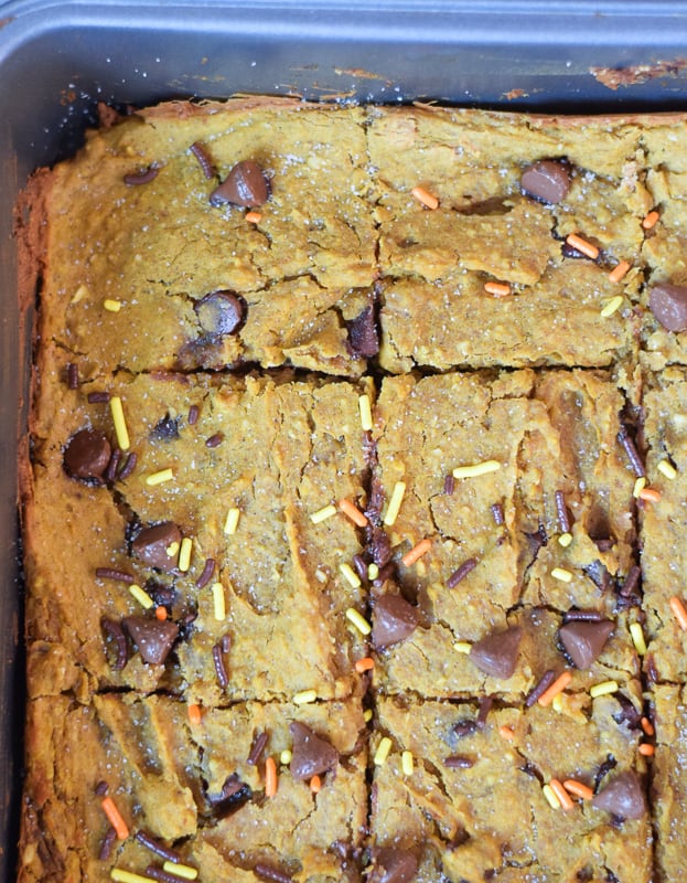 Closeup of pumpkin blondies in baking pan with sprinkles and chocolate chips