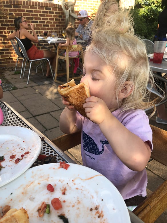 toddler eating pizza