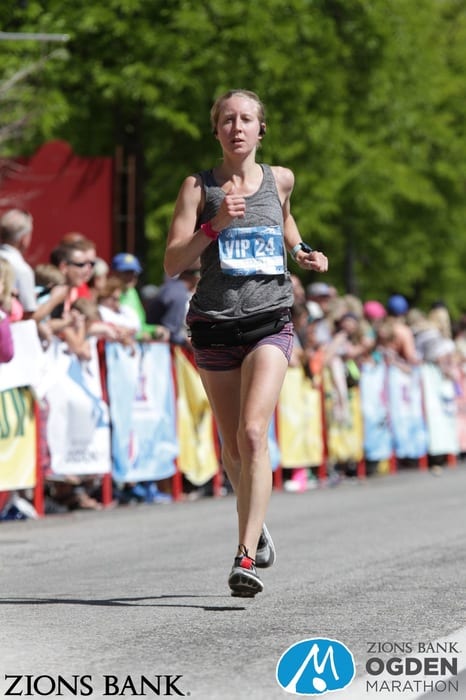 girl crossing finish line at Ogden Marathon in Utah 