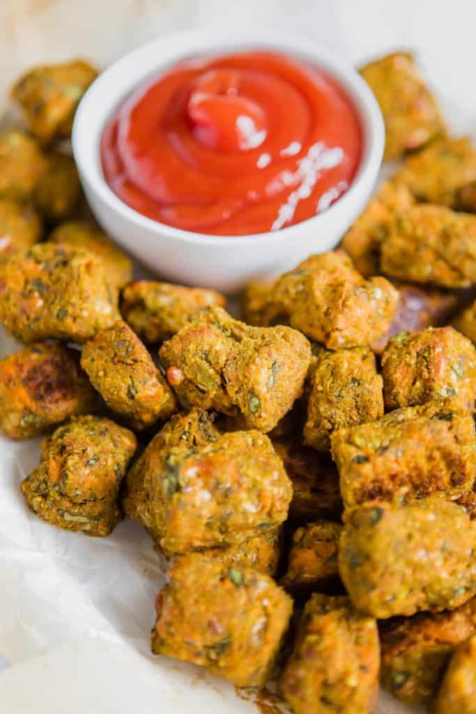 Spinach Sweet Potato Tots close up with ketchup in white bowl 