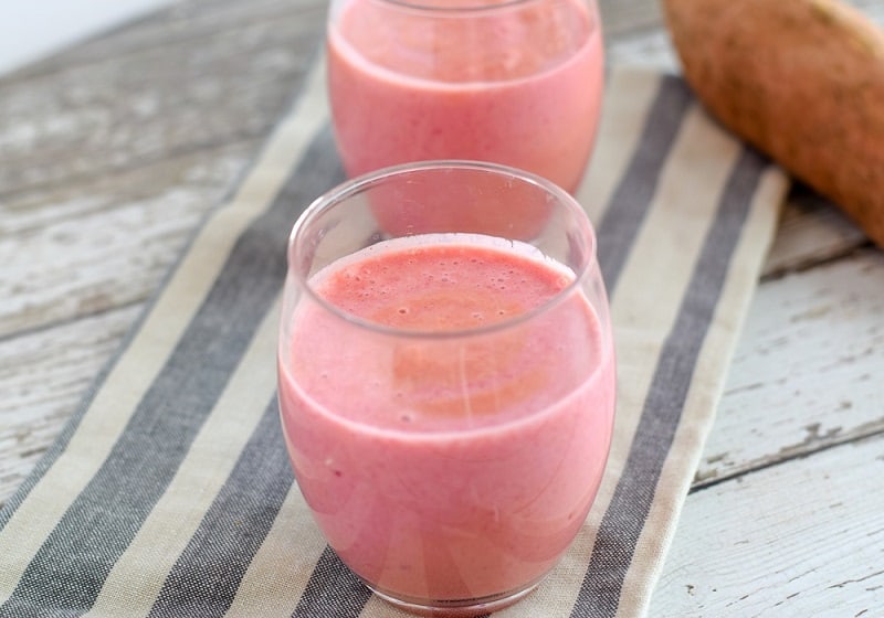 Sweet potato smoothie recipe in clear glasses on striped napkin