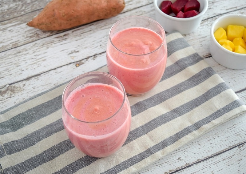 Sweet Potato Smoothie in clear glasses on striped napkin