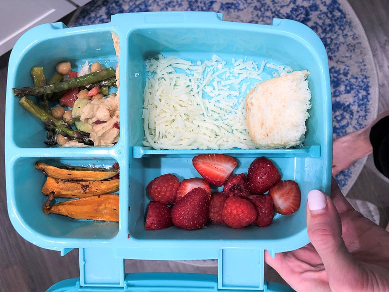 Bentgo lunch box with shredded cheese, sweet potato fries, fruit and mixed vegetables