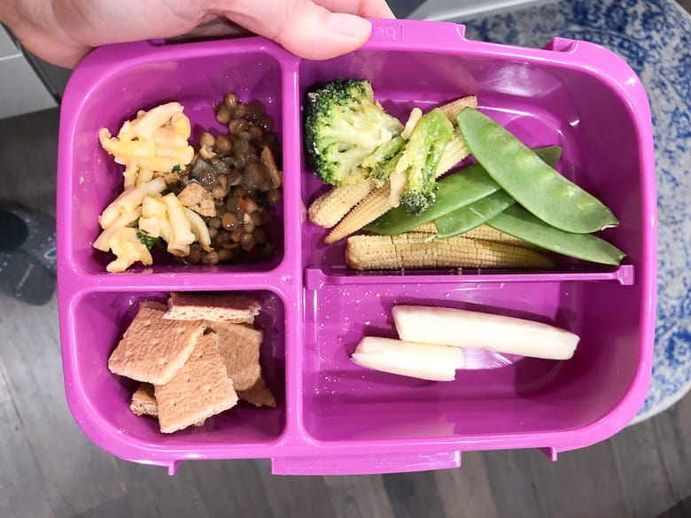 Bentgo lunch box with string cheese, vegetables, graham crackers, mac and cheese