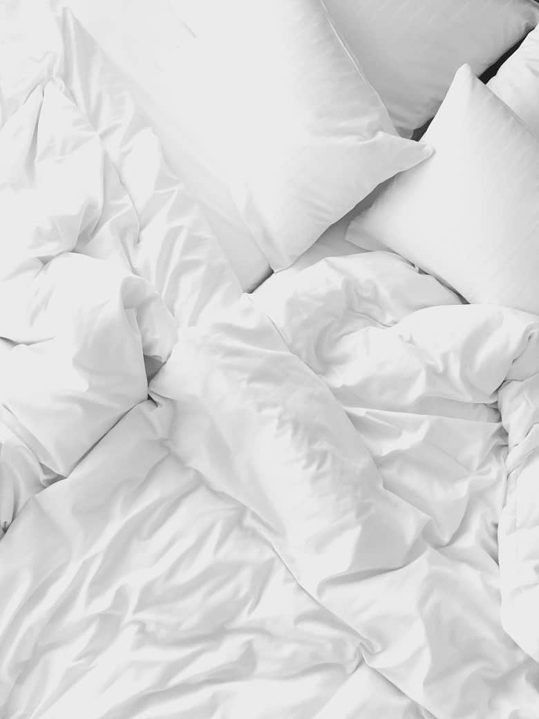 bed white white sheets and white pillowcase